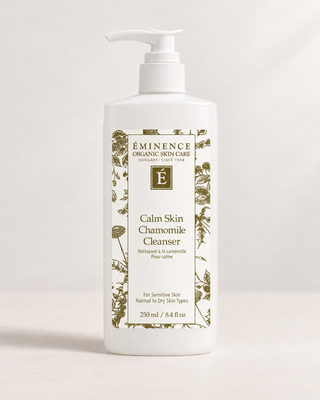 A 250 ml white pump bottle of Eminence Organic Skin Care Calm Skin Chamomile Cleanser, featuring a white label with green botanical illustrations and gold lettering, set against a clean white background.
